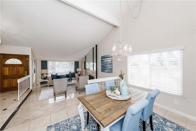 dining area with plenty of natural light, light tile patterned floors, lofted ceiling with beams, and a chandelier