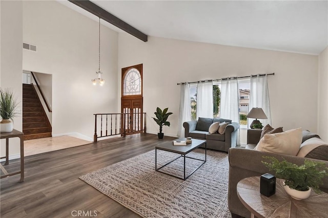 living room with hardwood / wood-style flooring, a chandelier, high vaulted ceiling, and beamed ceiling