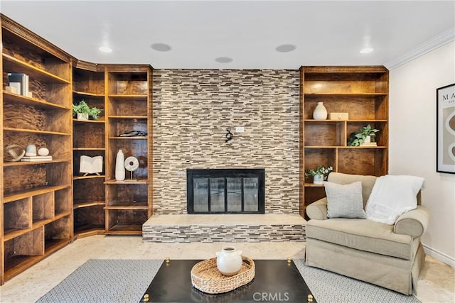 living room featuring a tiled fireplace and crown molding