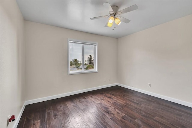 empty room with ceiling fan and dark hardwood / wood-style flooring