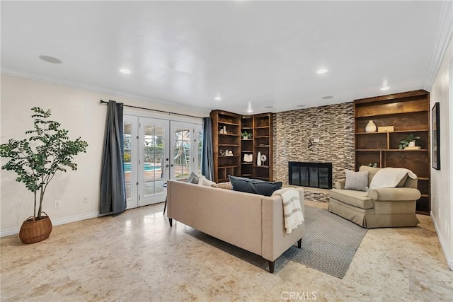 living room featuring ornamental molding, built in shelves, a fireplace, and french doors