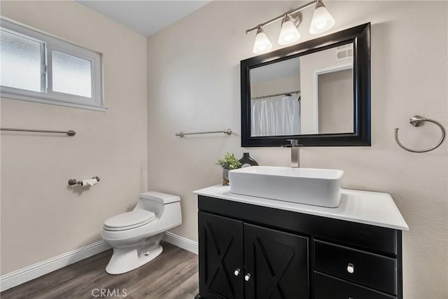 bathroom with vanity, hardwood / wood-style floors, and toilet