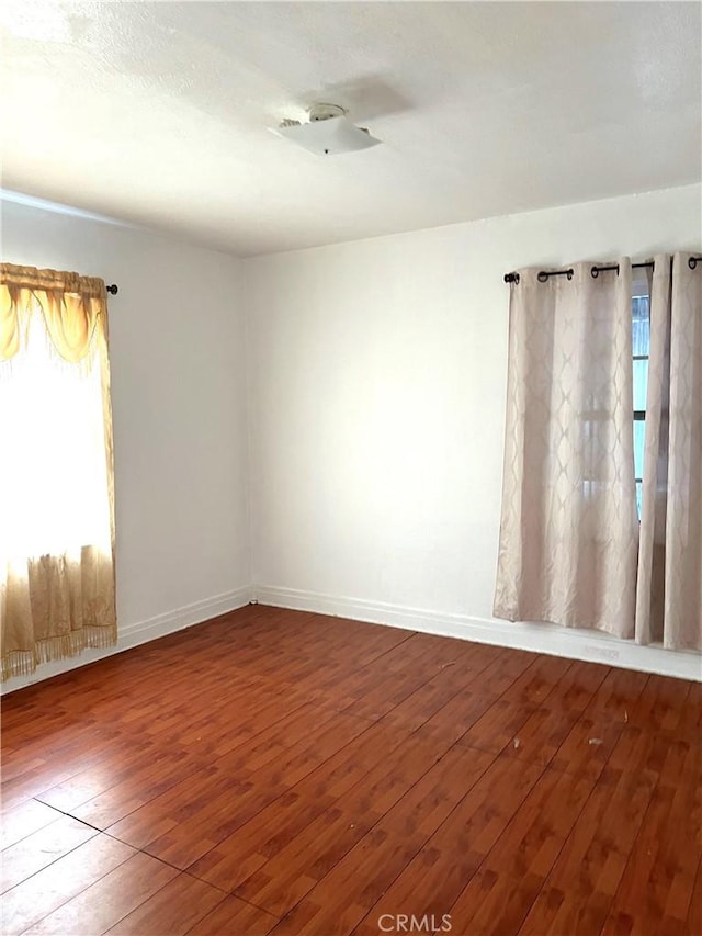 unfurnished room with wood-type flooring