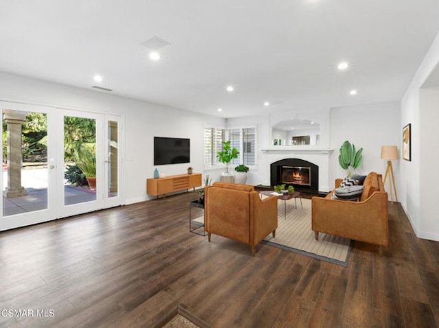 living room featuring dark wood-type flooring and a wealth of natural light