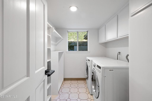 laundry room featuring cabinets and separate washer and dryer