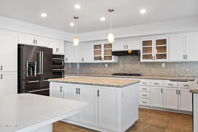 kitchen featuring a kitchen island, decorative light fixtures, white cabinets, and black appliances