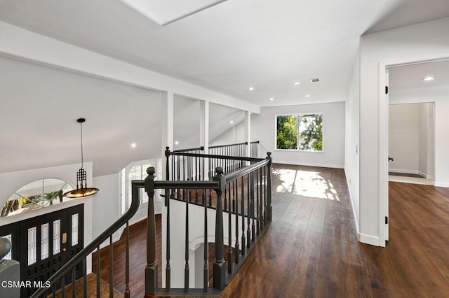 hall featuring lofted ceiling and dark hardwood / wood-style floors