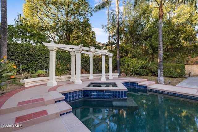 view of pool with an in ground hot tub and a pergola