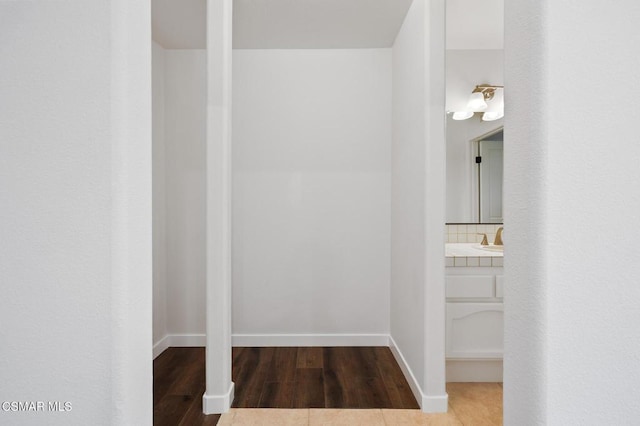 bathroom featuring hardwood / wood-style flooring, vanity, and tasteful backsplash