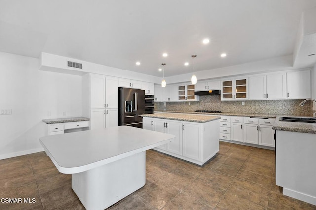 kitchen featuring sink, black appliances, a center island, pendant lighting, and white cabinets