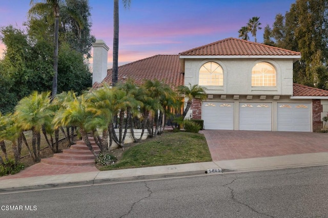 mediterranean / spanish-style house featuring a garage