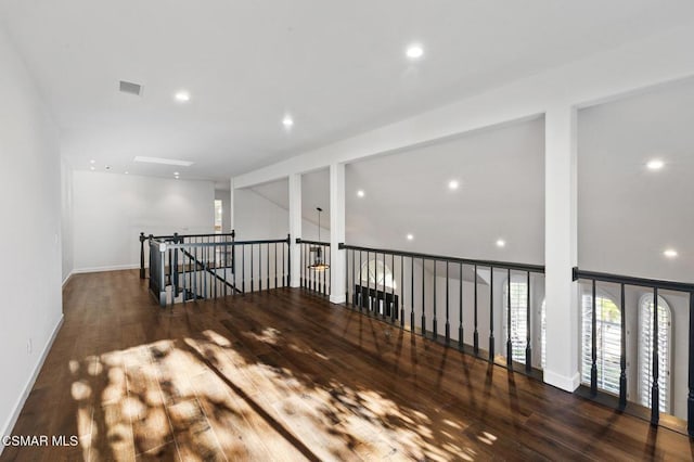 spare room with dark hardwood / wood-style flooring and lofted ceiling