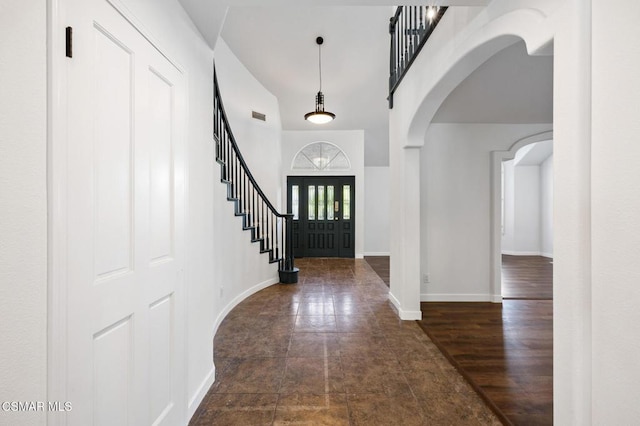 entryway featuring a towering ceiling