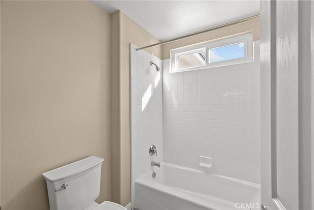 bathroom with tub / shower combination and toilet