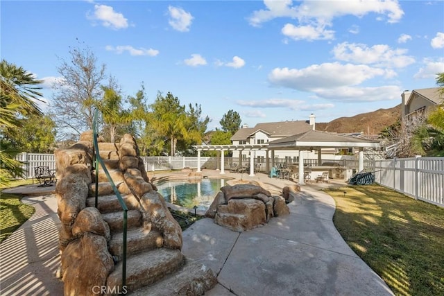 view of swimming pool with a mountain view, a patio area, and a pergola