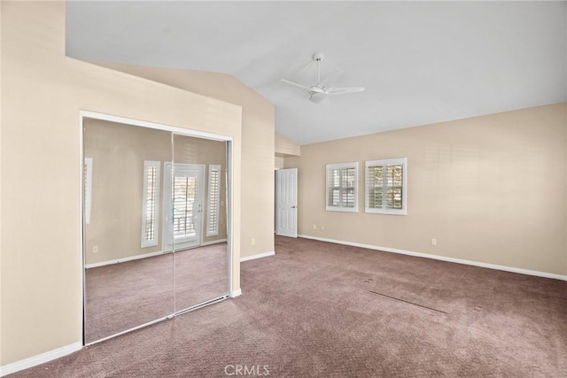 unfurnished bedroom with a closet, ceiling fan, vaulted ceiling, and carpet