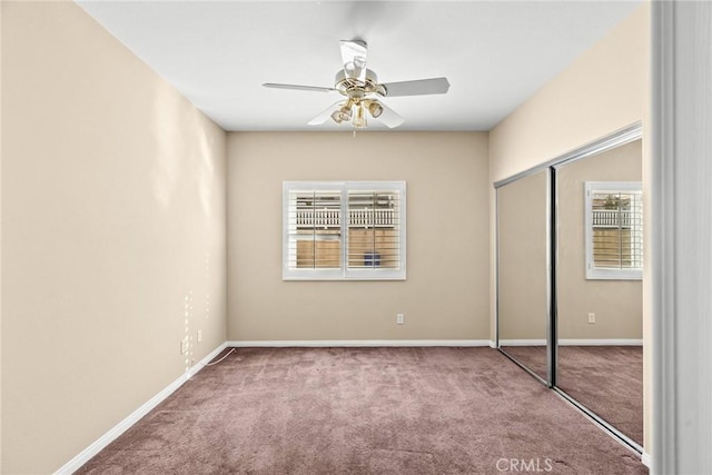 unfurnished bedroom featuring light colored carpet, ceiling fan, and a closet