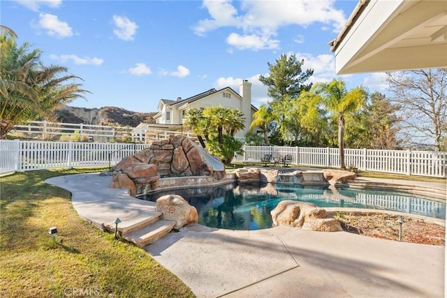 view of swimming pool featuring a mountain view, a patio, and a water slide