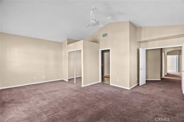 interior space featuring dark carpet, high vaulted ceiling, and ceiling fan