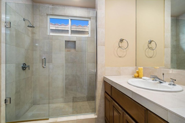 bathroom with vanity and a shower with shower door