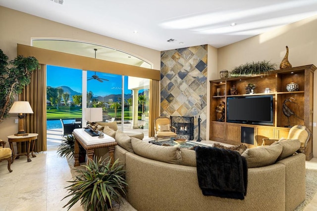 living room featuring a mountain view and a tile fireplace