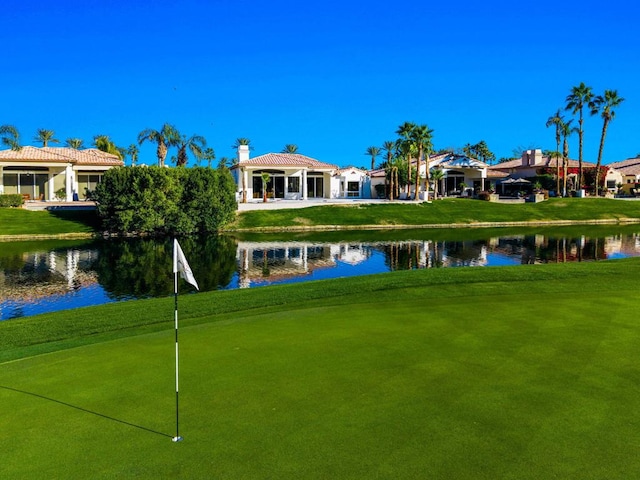 surrounding community featuring a water view, a gazebo, and a lawn