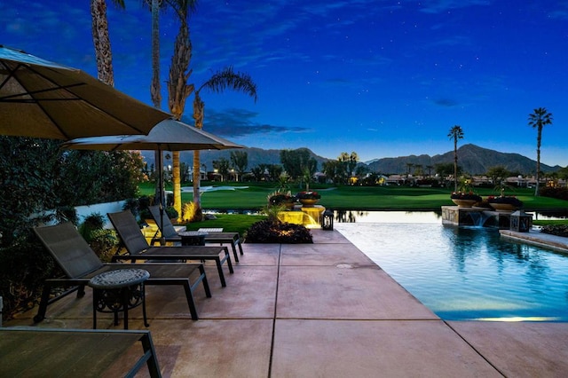 exterior space featuring a mountain view and pool water feature