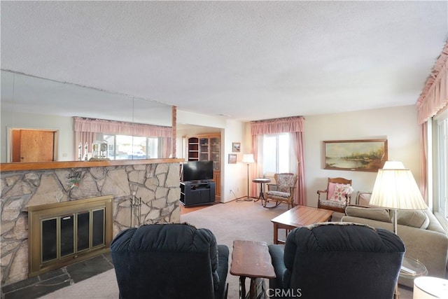 carpeted living room with a fireplace and a healthy amount of sunlight