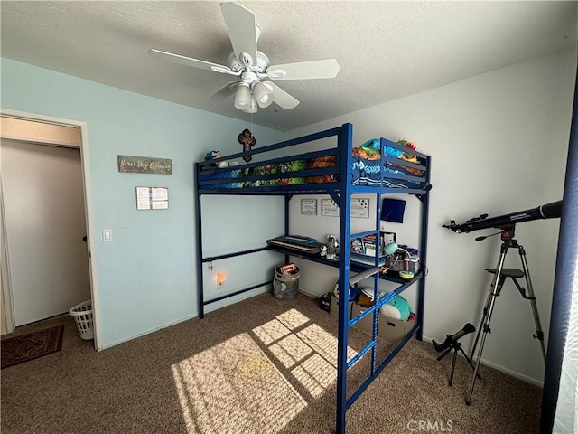 bedroom featuring ceiling fan, carpet flooring, and a textured ceiling