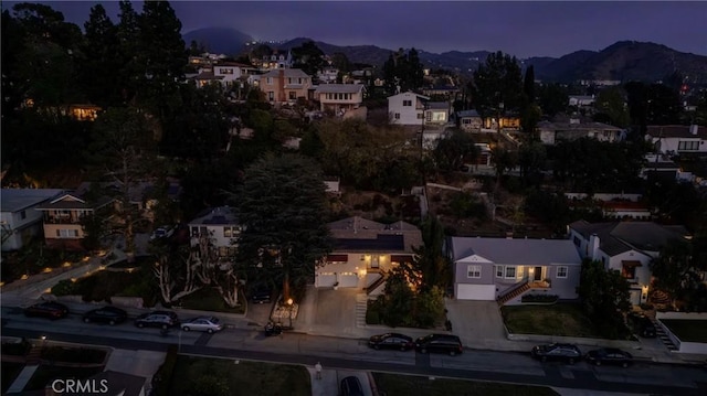 aerial view at dusk featuring a mountain view