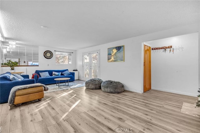 living room featuring light hardwood / wood-style floors and a textured ceiling