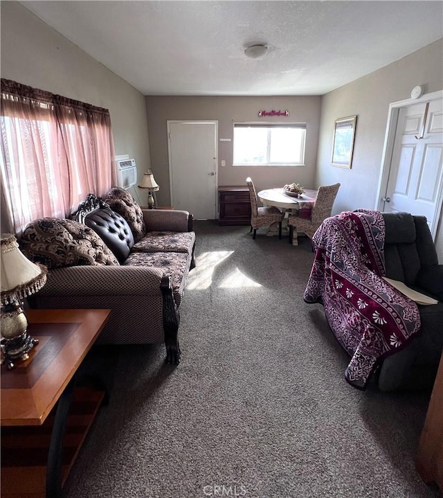 living room with carpet floors and an AC wall unit