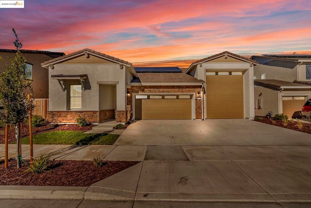 view of front of home featuring a garage and solar panels