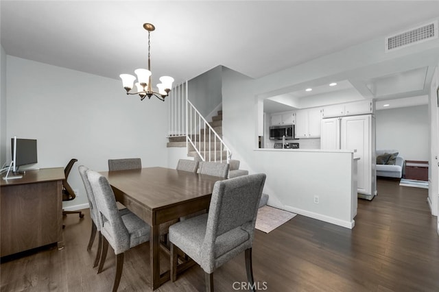 dining room featuring dark hardwood / wood-style flooring and a chandelier