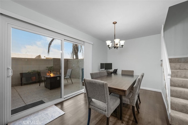 dining room featuring an inviting chandelier and dark wood-type flooring