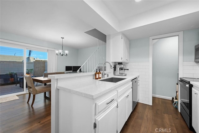 kitchen with stainless steel appliances, sink, and white cabinets