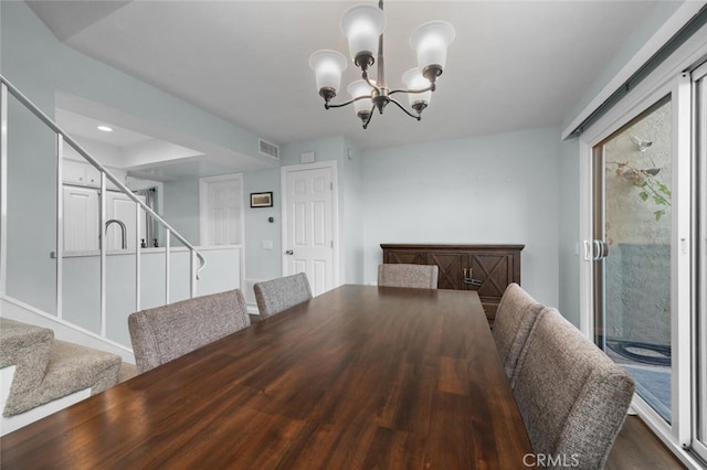 unfurnished dining area featuring dark hardwood / wood-style flooring and a notable chandelier