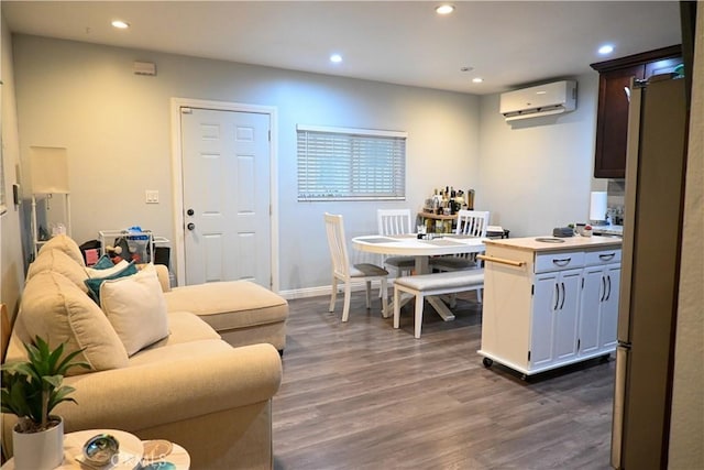 interior space with dark hardwood / wood-style flooring, white cabinets, and a wall unit AC