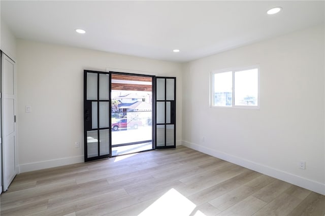 spare room featuring light hardwood / wood-style floors