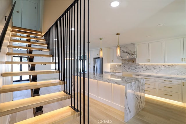 staircase featuring hardwood / wood-style flooring