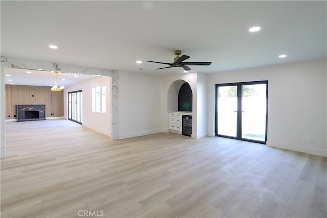 unfurnished living room featuring light hardwood / wood-style flooring and ceiling fan