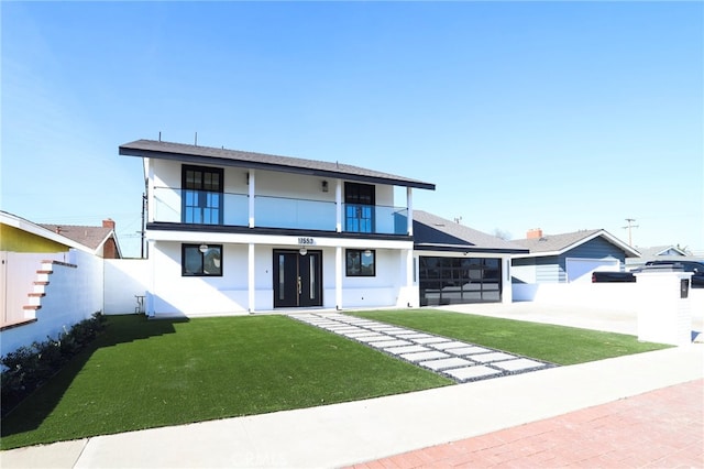 view of front of house featuring a front yard and a balcony