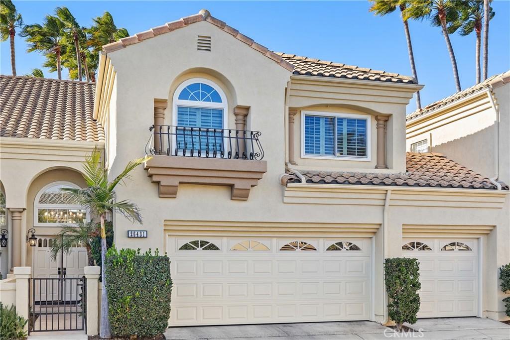 mediterranean / spanish-style home featuring a garage and a balcony