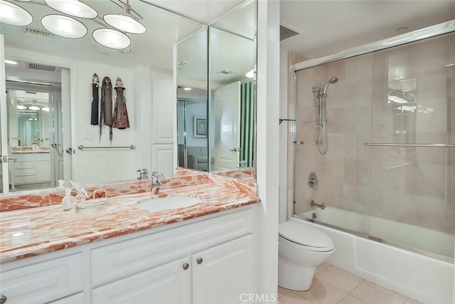 full bathroom featuring vanity, toilet, bath / shower combo with glass door, and tile patterned floors