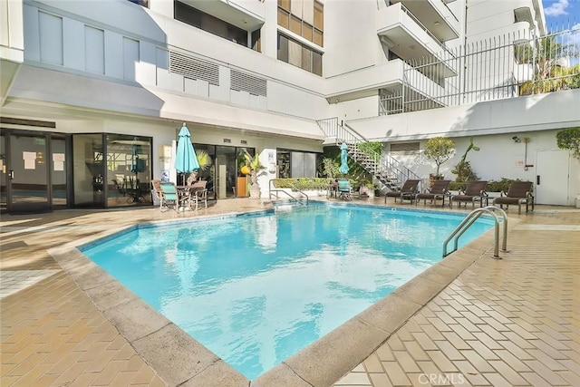 view of swimming pool with a patio