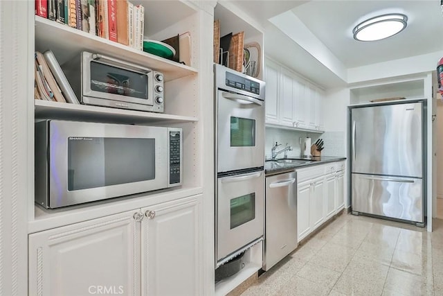 kitchen with sink, white cabinetry, and stainless steel appliances