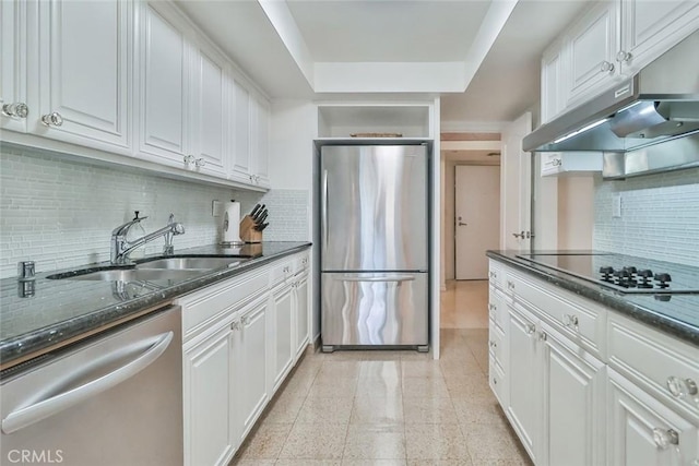 kitchen with sink, white cabinets, tasteful backsplash, and appliances with stainless steel finishes