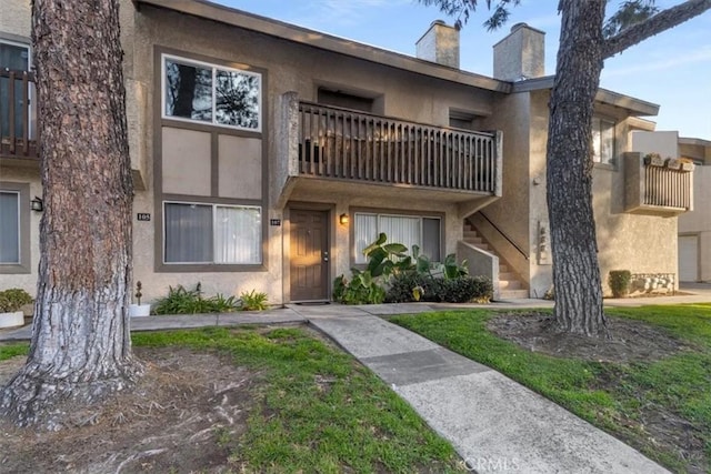 view of front of property with a balcony