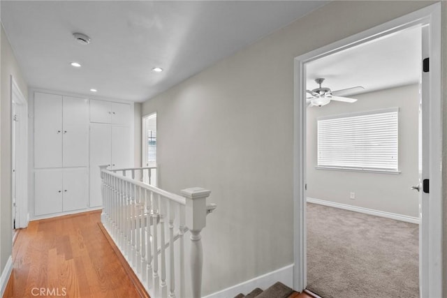 hall featuring light colored carpet