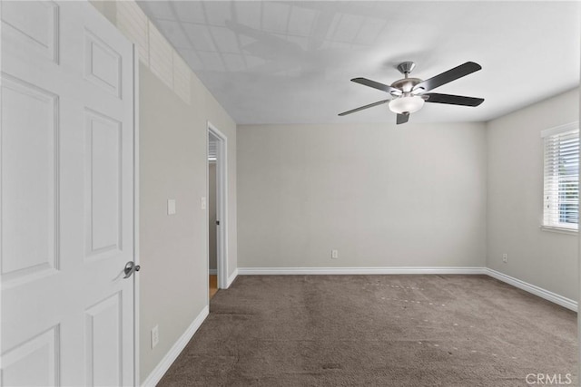 carpeted spare room with ceiling fan